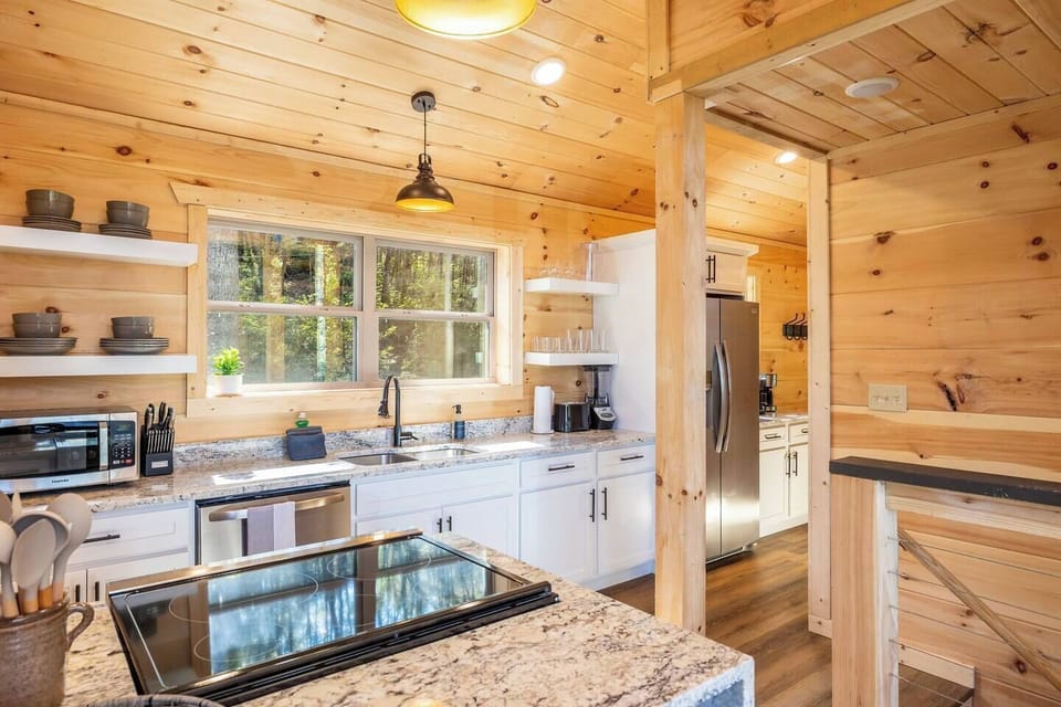 Main level well-stocked kitchen and breakfast bar, seating for 2.