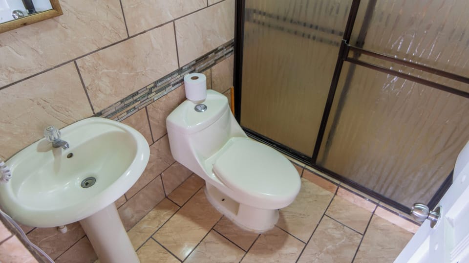 Bathroom 1: toilet, basin and shower enclosure.