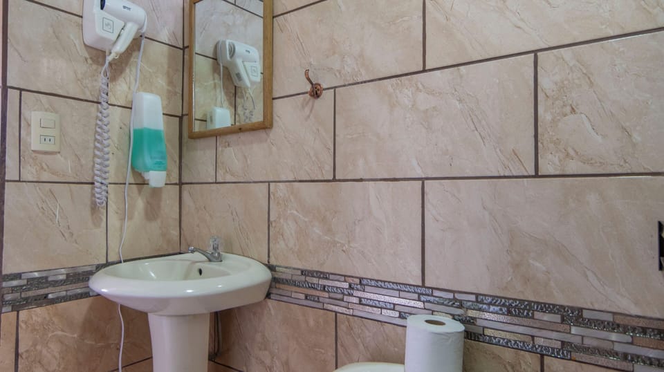 Bathroom 1: washbasin and mirror above the tiled wall.