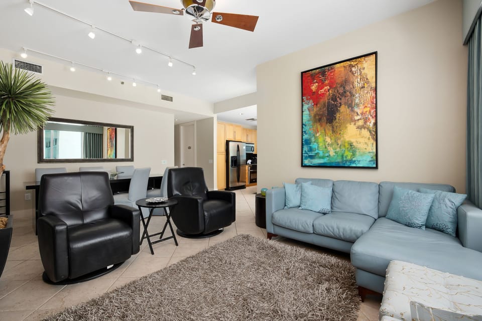 Open-concept living space with plush seating, modern décor, and seamless flow to the kitchen and dining areas.