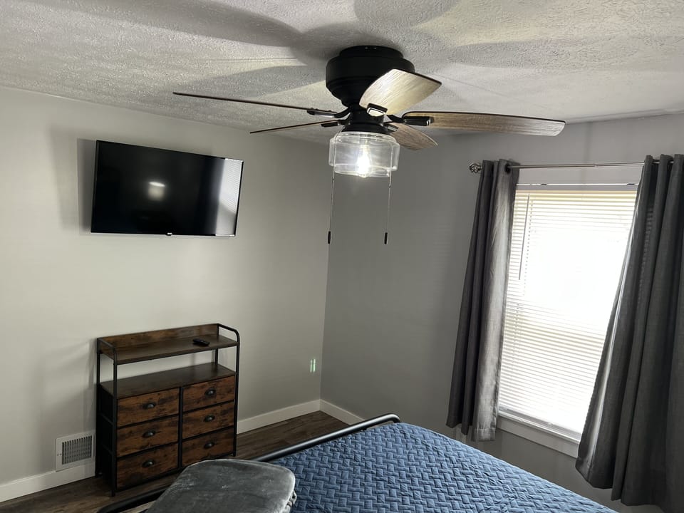 First bedroom with 40" smart tv and dresser