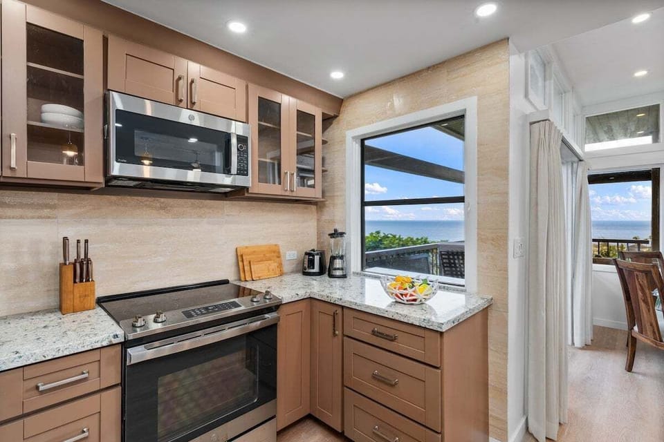 Modern kitchen with stainless microwave, range, and generous prep space, designed for both everyday meals and entertaining.