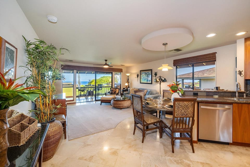 Elegant open-concept space combining living and dining areas, ideal for relaxing or entertaining with tropical views.