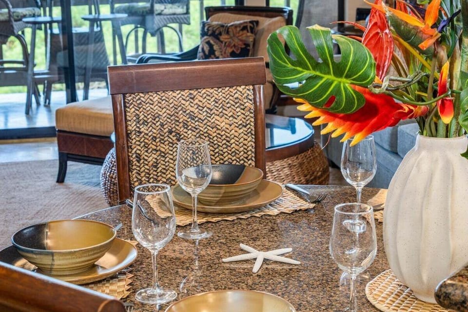Beautiful dining setup with tropical floral centerpiece, perfect for enjoying meals in a relaxed island atmosphere.