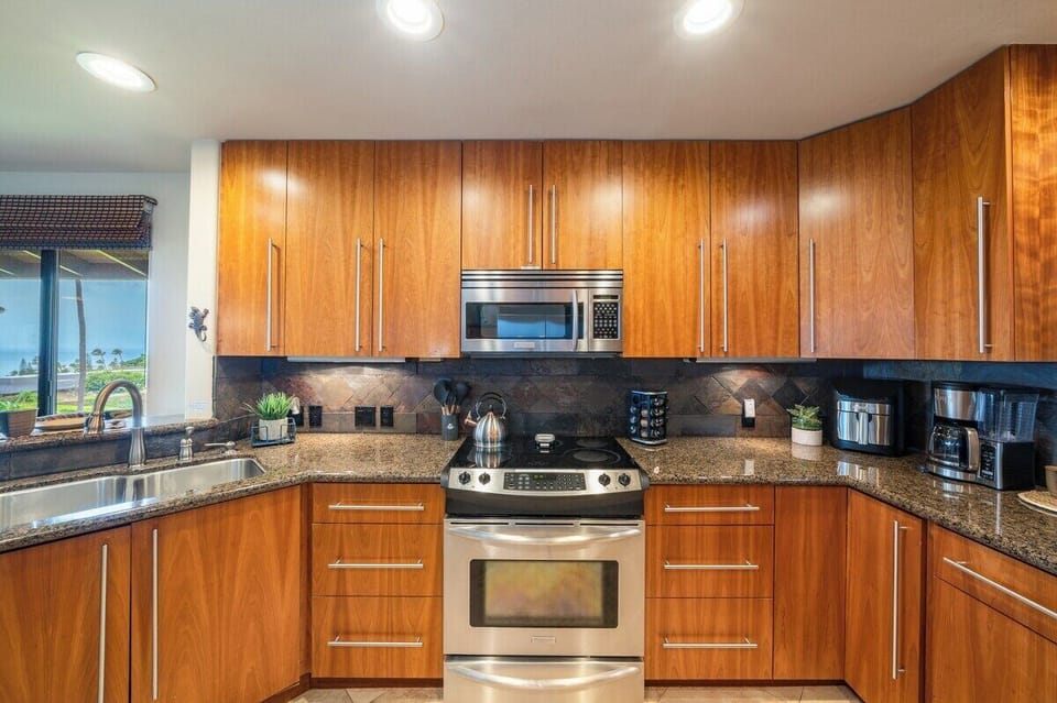 Contemporary kitchen with stainless steel oven, sleek countertops, and plenty of storage for a comfortable stay.