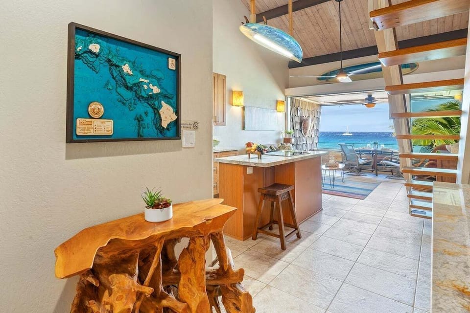 Entry hallway features island artwork, seating accent, and coastal character.