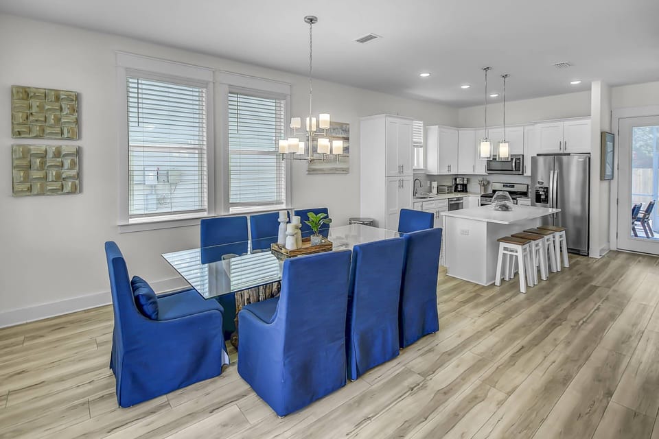 The dining area features a large gorgeous driftwood table with seating for up to 10 people and an additional 4 stools at the kitchen island!