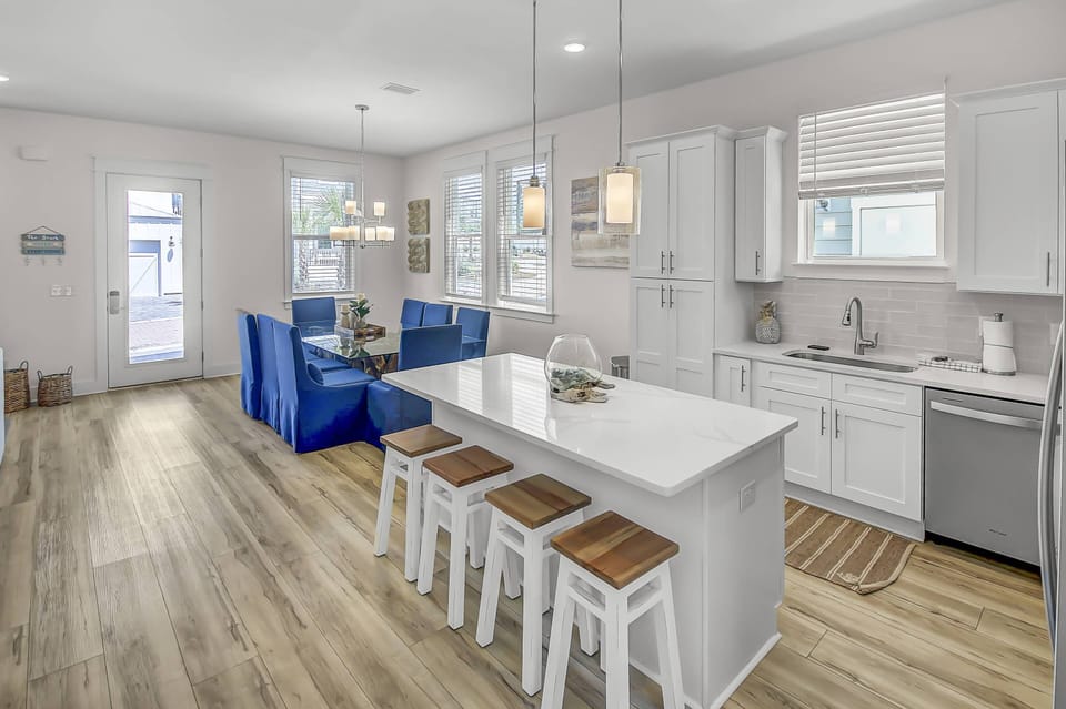 The dining area features a large gorgeous driftwood table with seating for up to 10 people and an additional 4 stools at the kitchen island!
