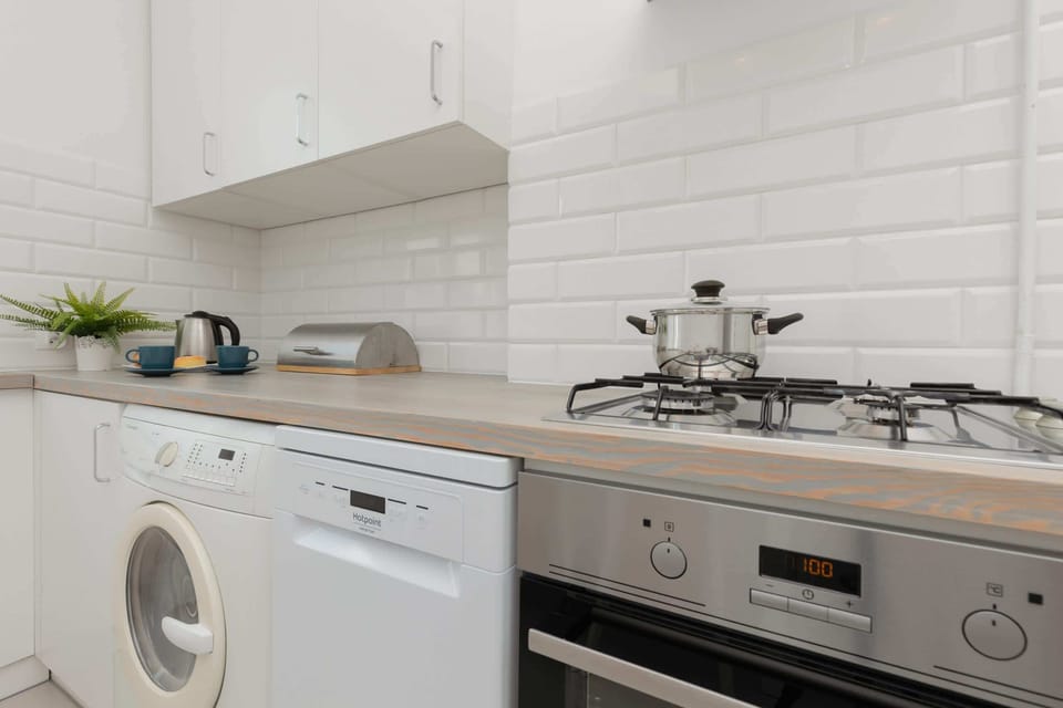 The kitchen's contemporary decor complements the apartment's style.