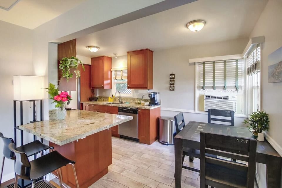 Dining table for three guests and window a/c unit!