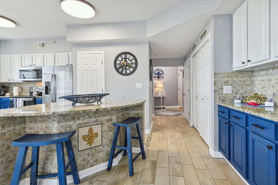 Looking into the front foyer, wet bar, & kitchen.