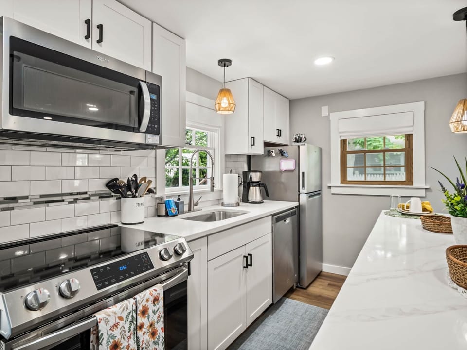 Fully stocked kitchen, stainless steel appliances, induction oven, dishwasher, coffee maker