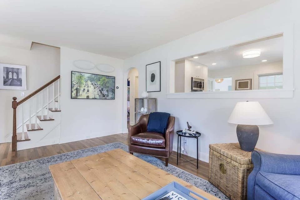 Enjoy the warm ambiance of our living room, featuring an inviting window that creates a seamless connection to the kitchen, fostering an open and welcoming atmosphere.