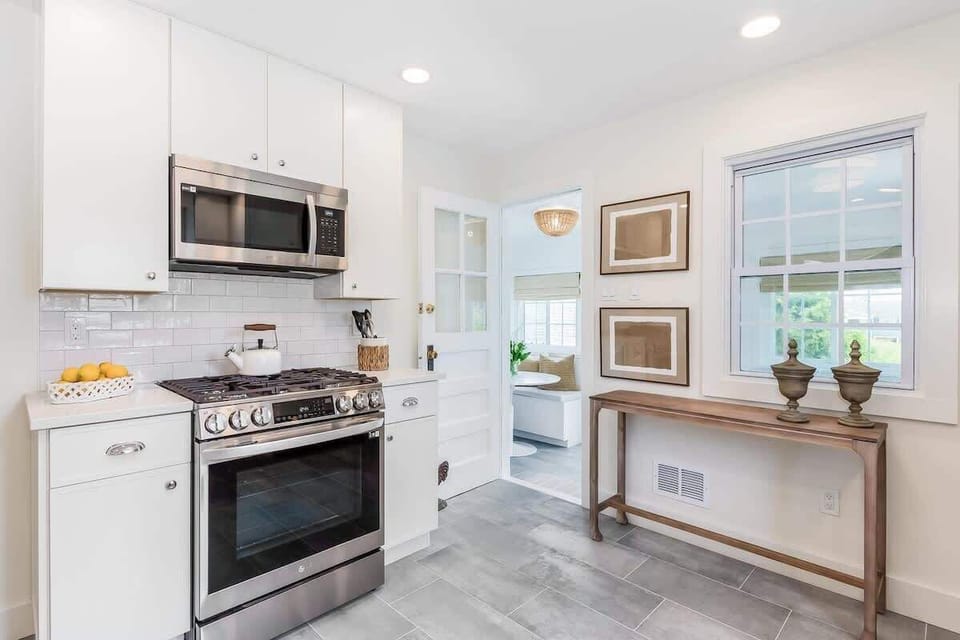 Kitchen equipped with new appliances and conveniently located adjacent to the dining banquet.