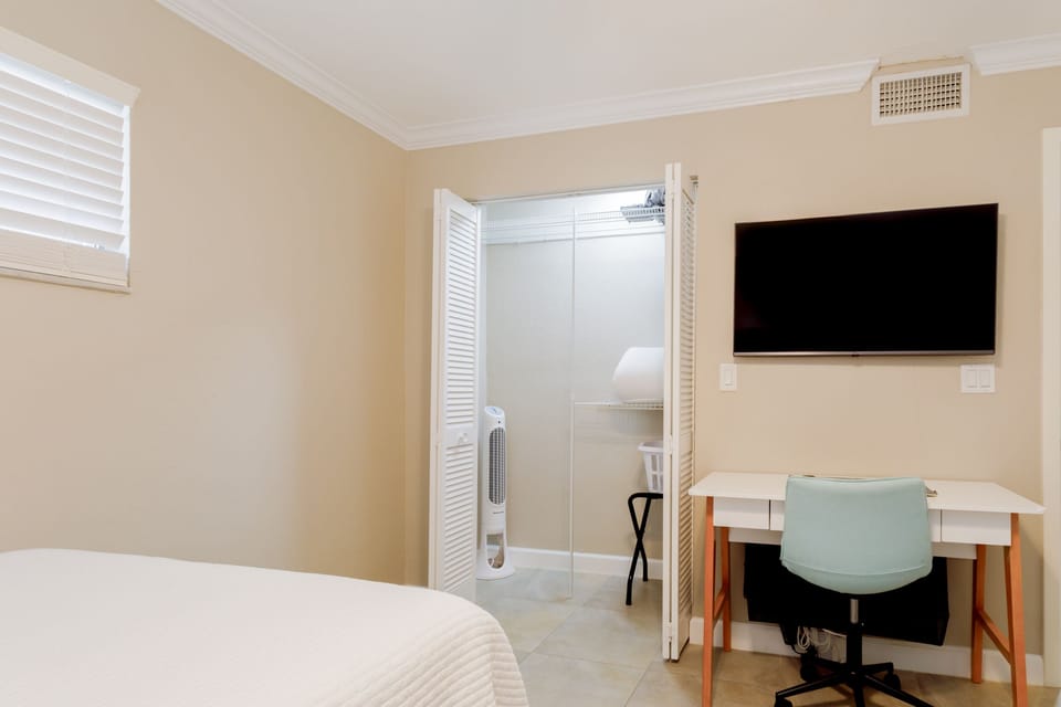 Second bedroom also features spacious closet, work space, Smart TV, floor fan and luggage rack.