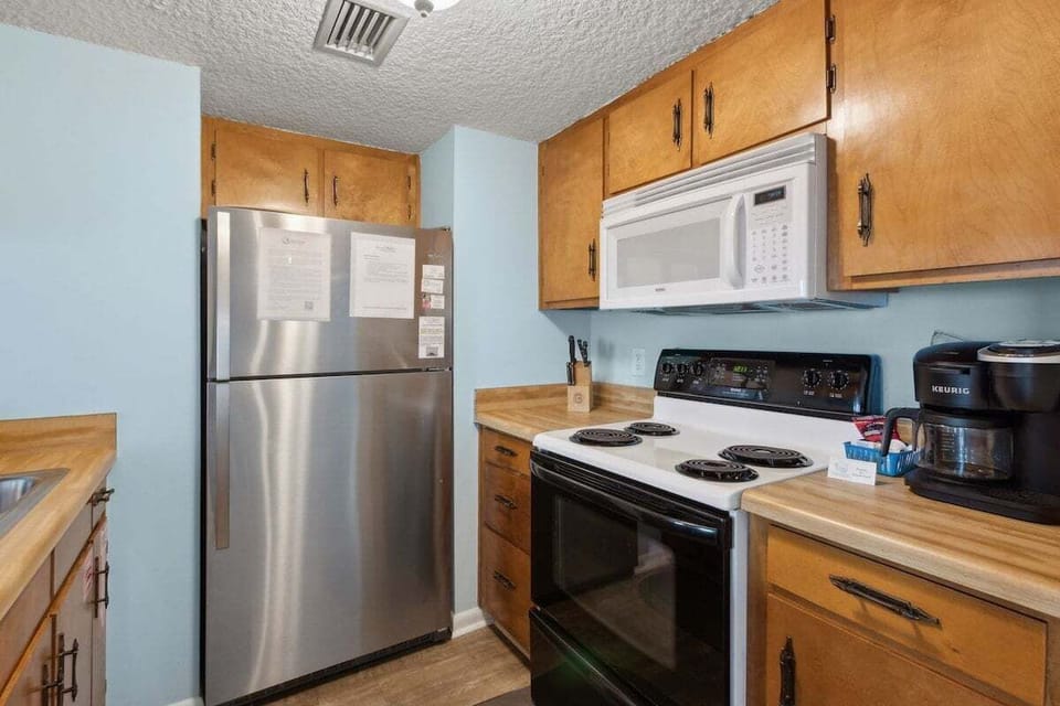Convenient kitchen with a full-size refrigerator, range, microwave, and everything needed for easy meals.