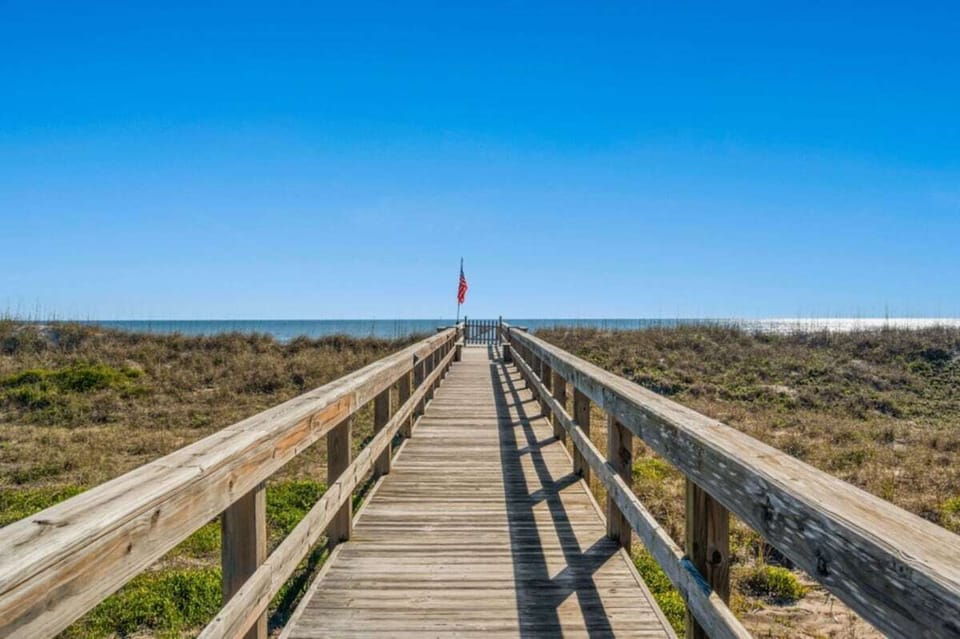 Scenic beach access boardwalk leading over the dunes toward the shoreline.