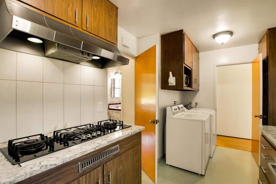 Also nestled in the kitchen are the laundry units