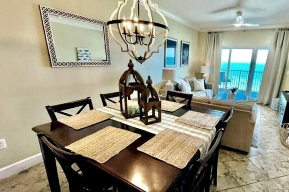 Dining room table overlooking the living room, balcony, and ocean. One of our favorite places to hang out and play games/cards.