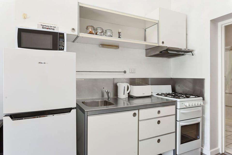 This bright and airy kitchen is perfect for cooking and entertaining. The open layout creates a sense of spaciousness and connection.