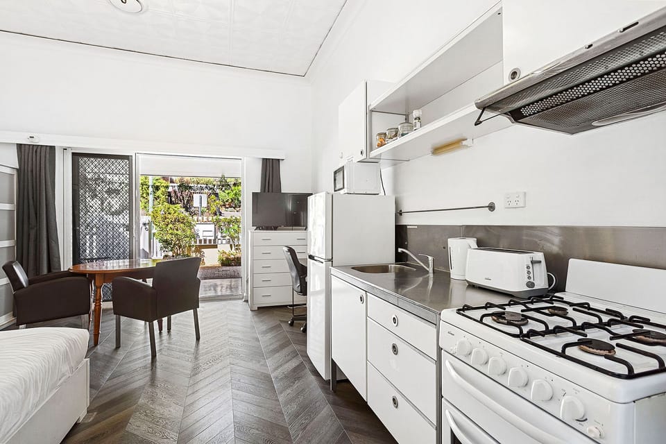 This bright and airy room combines a well-equipped kitchen with a cozy living and dining area, perfect for a comfortable stay.