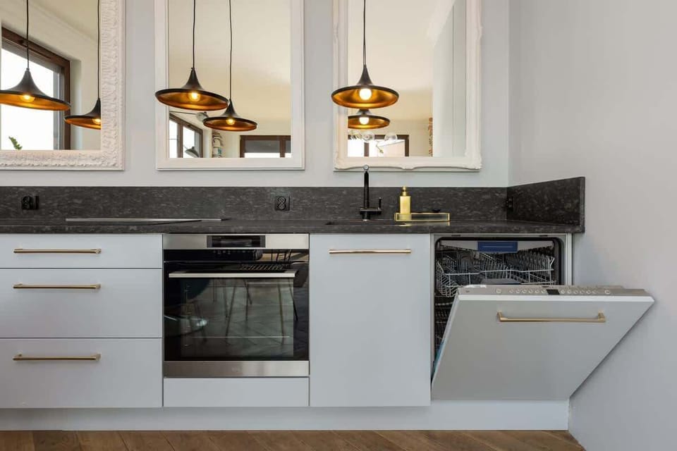 Fully equipped kitchenette with a dishwasher and a functional dining area.