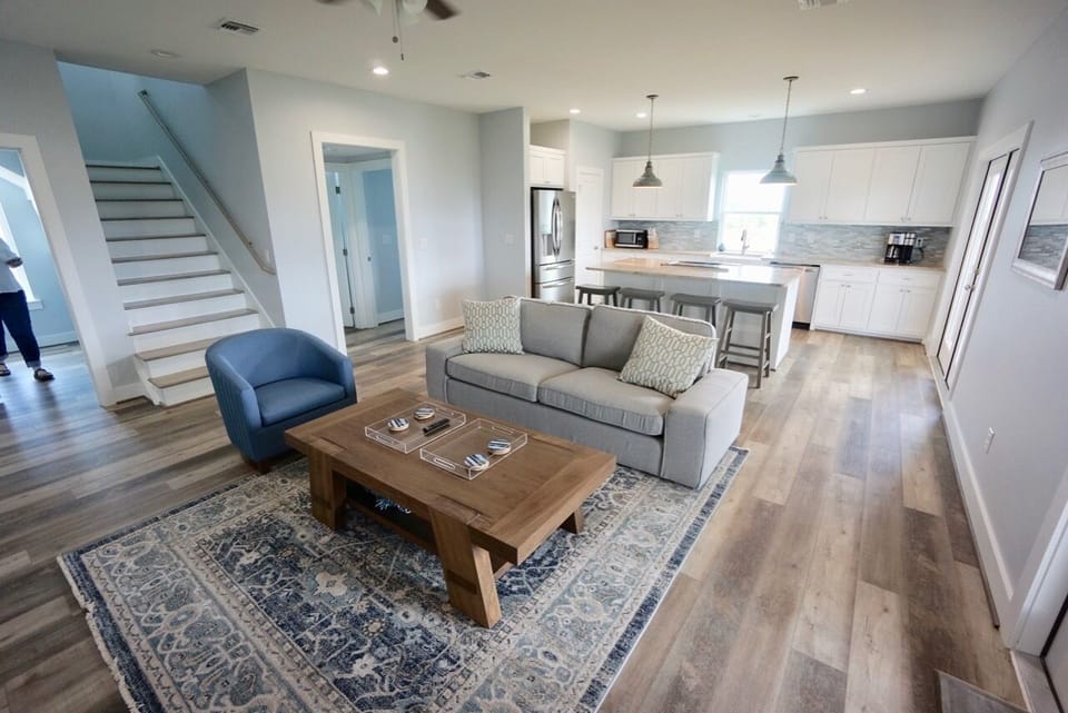 Open concept living and kitchen with stairs leading to 2nd floor bedroom