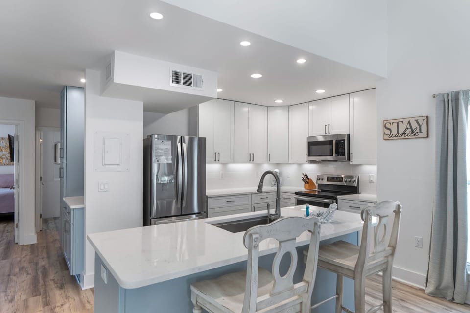 Your fully-equipped modern kitchen features granite countertops, stainless steel appliances, and breakfast bar seating for memorable family meals together.