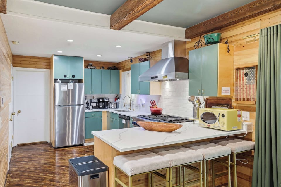A fully equipped kitchen with everything you need—fridge, stove, microwave, and dishwasher—perfect for cooking up delicious meals during your stay.