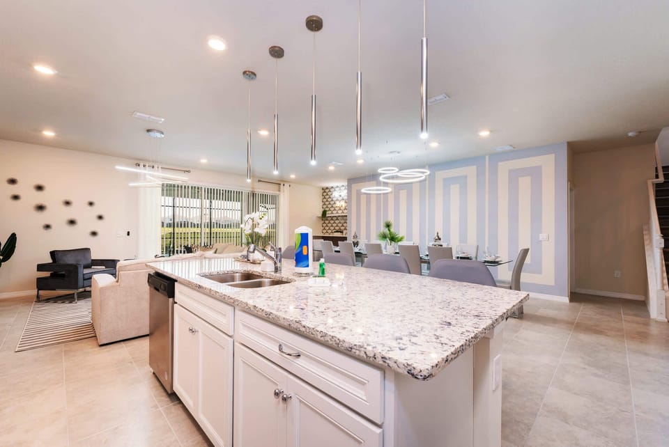 Experience luxury and comfort in this modern kitchen and dining area, perfect for entertaining large groups.