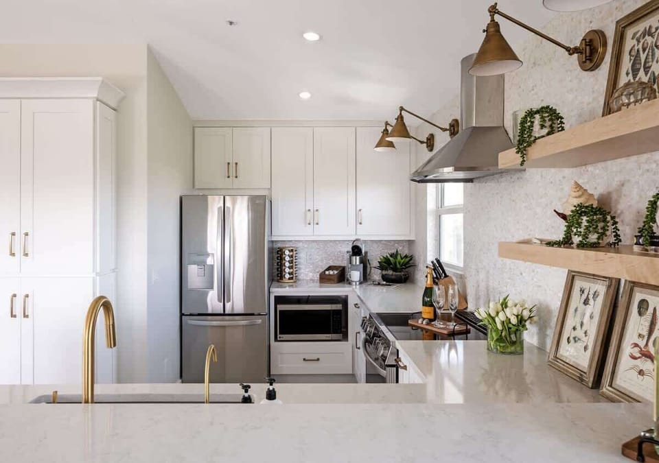 The gourmet kitchen, a focal point of the home, features sleek countertops, top-of-the-line appliances, and every ammenity you need to create your perfect meal.