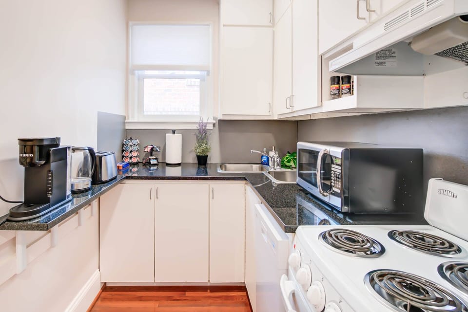 Create culinary delights in this cozy, fully equipped kitchen, nestled within a Heart of Old Town Alexandria apartment just steps from local food markets and dining treasures.