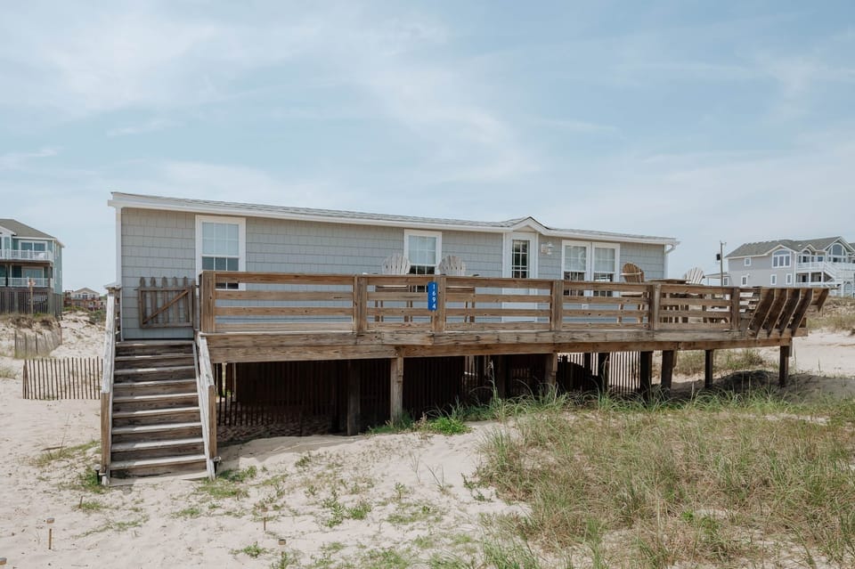 Nestled behind protective barrier dune, still providing unobstructed ocean views.