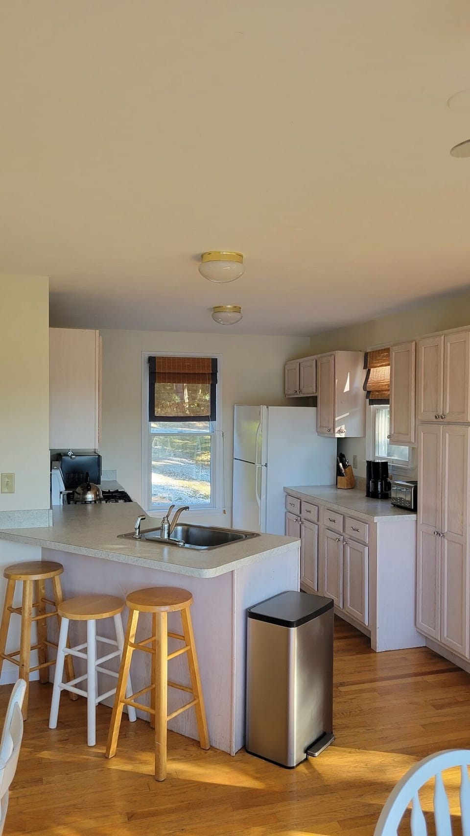 Kitchen with gas stove, dishwasher, fridge and small seating area