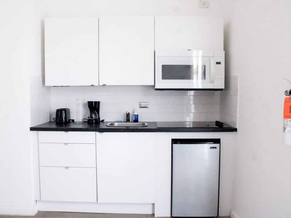 Fridge, microwave, coffee/tea maker, cookware/dishes/utensils
