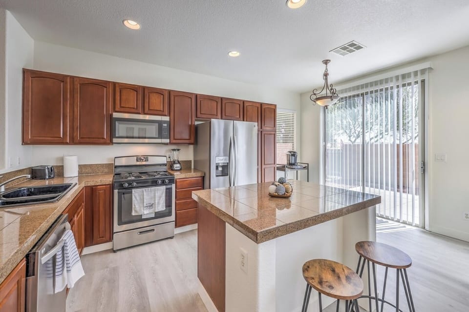 Kitchen with all the required cookware, appliances, and a coffee maker. 