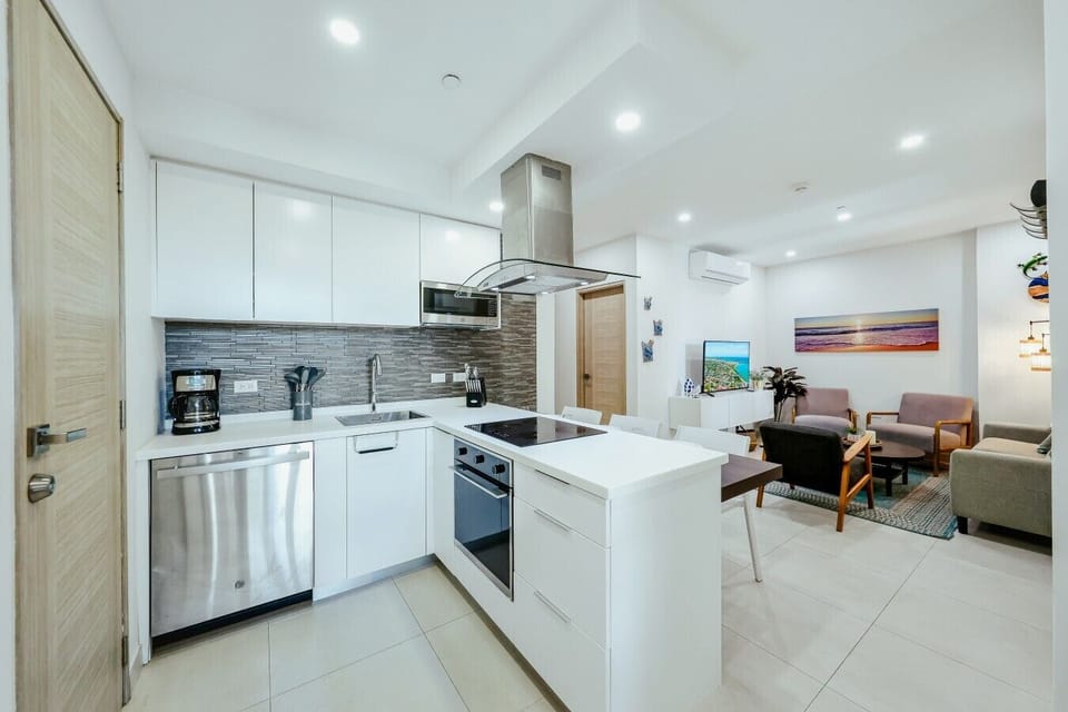 Fully equipped kitchen featuring modern appliances, cookware, essentials, and ample space for meal preparation.