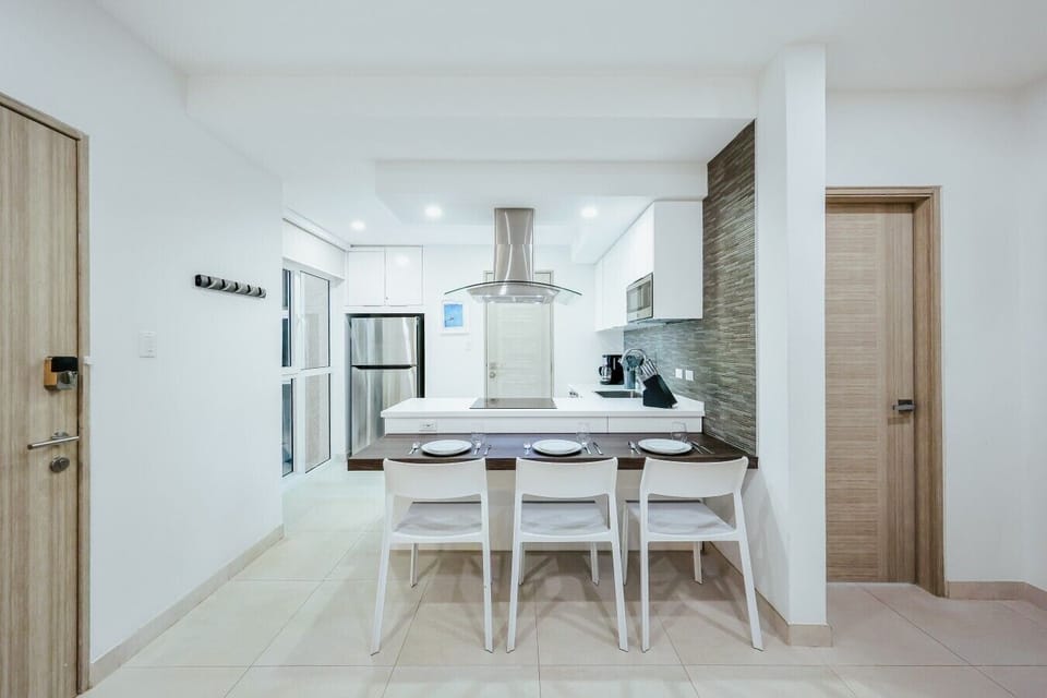 Fully equipped kitchen featuring modern appliances, cookware, essentials, and ample space for meal preparation.