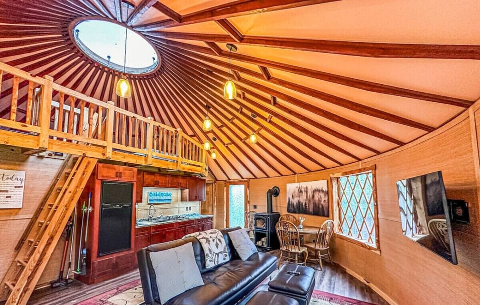 The living room features a spacious loft area, adding to the open, airy feel of the space.
