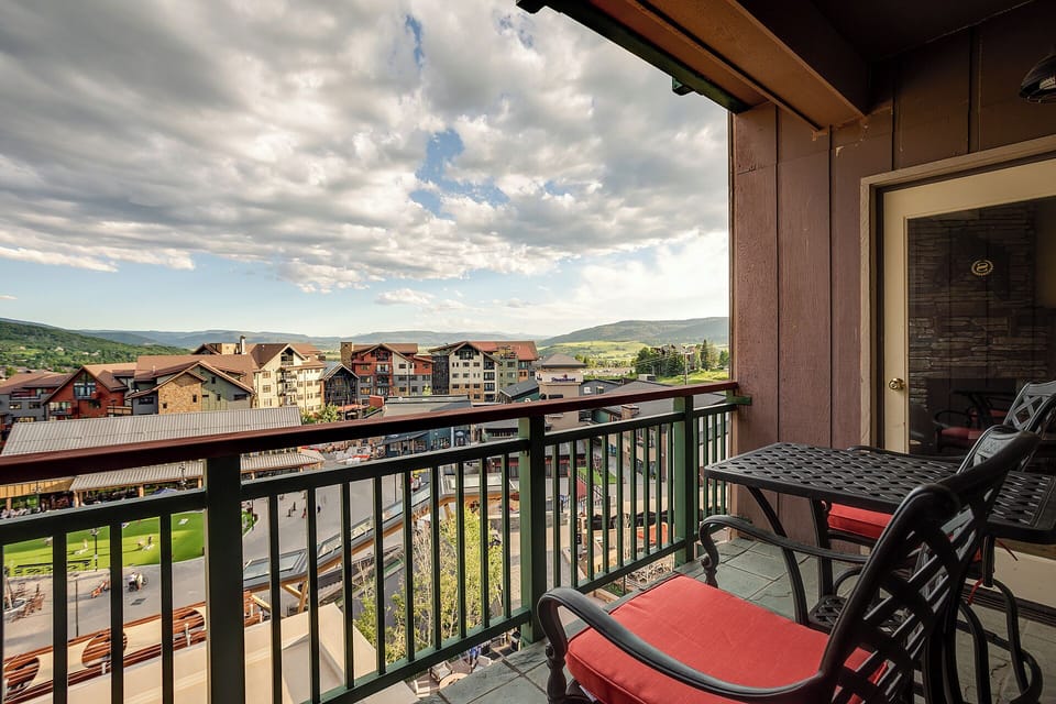 Unwind on your private balcony with comfortable seating as you take in panoramic views of the charming village and rolling mountains beyond.