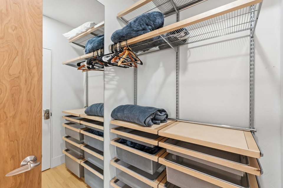 Your belongings find a home in this thoughtfully designed walk-in closet with custom shelving, hanging space, and plenty of room to unpack and settle in for your stay.