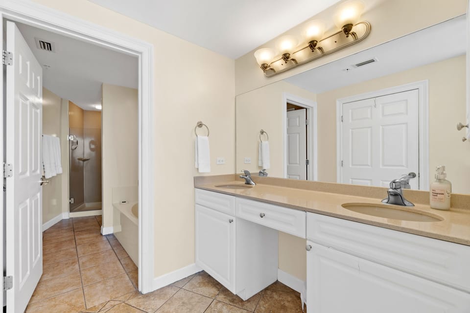 The ensuite primary bath is roomy, with double sinks and a vanity. Double sinks.