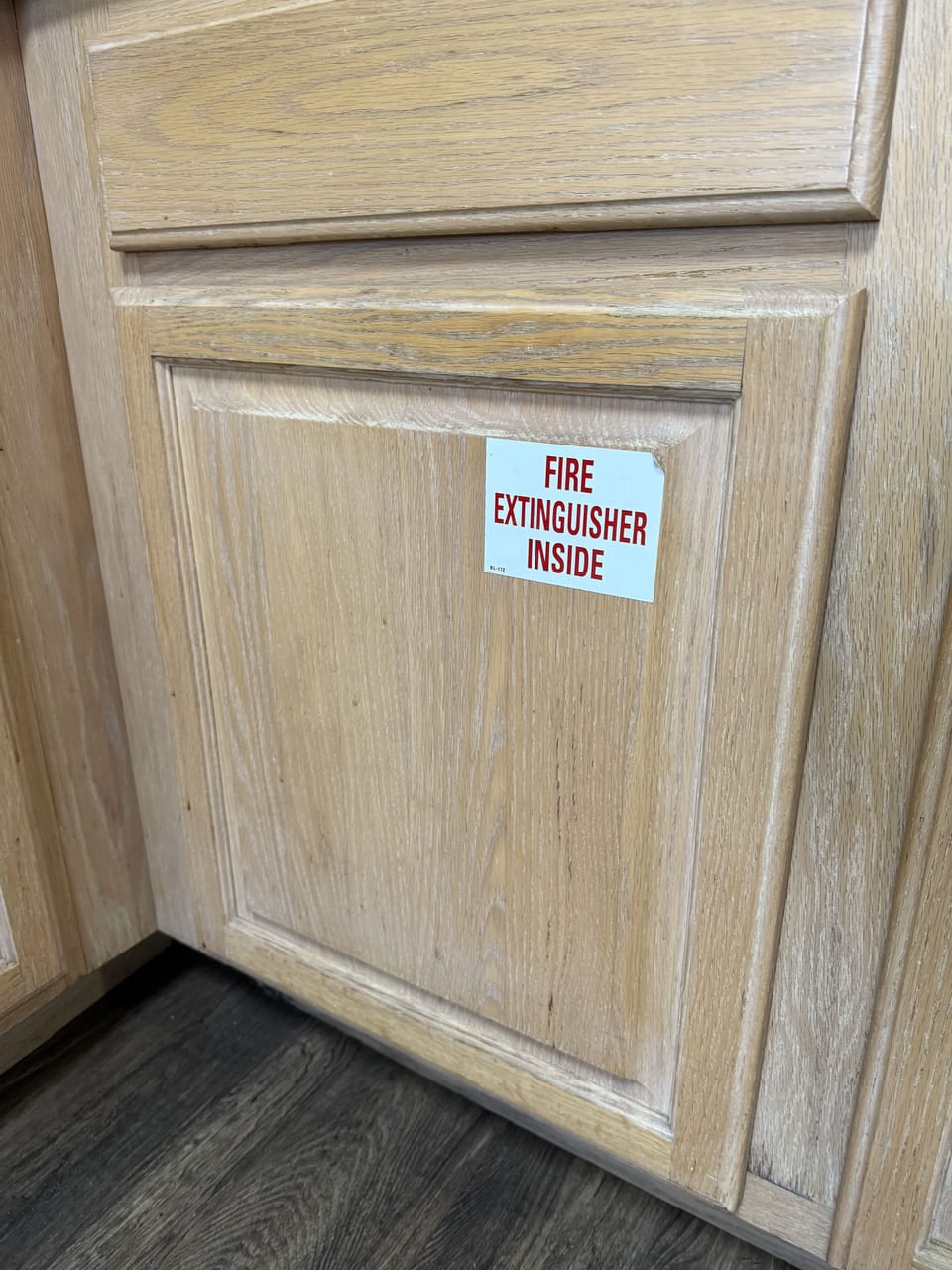 Sign notes where fire extinguisher is located.