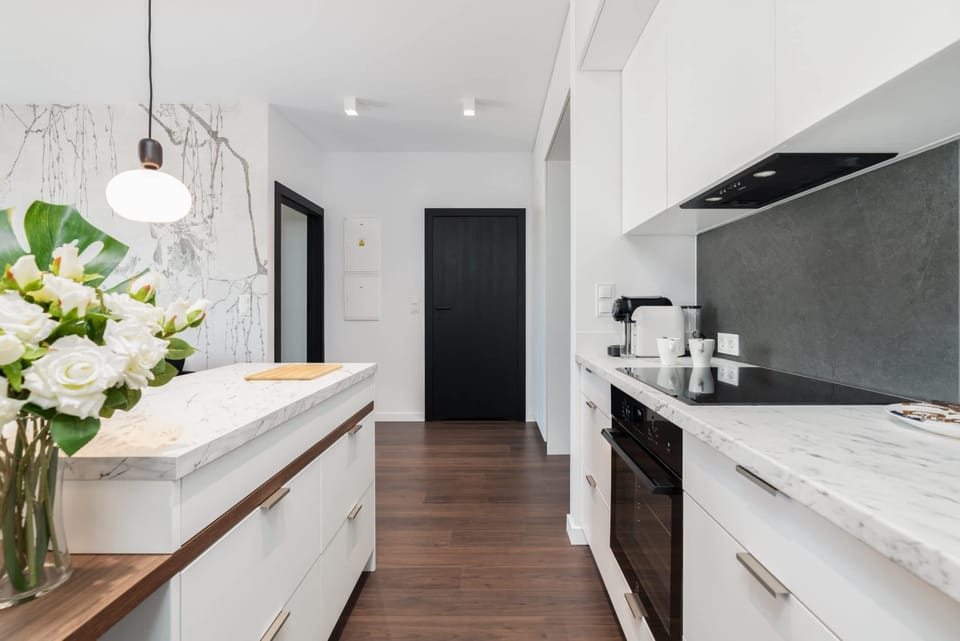 The sleek design of the kitchenette blending seamlessly with the living area.
