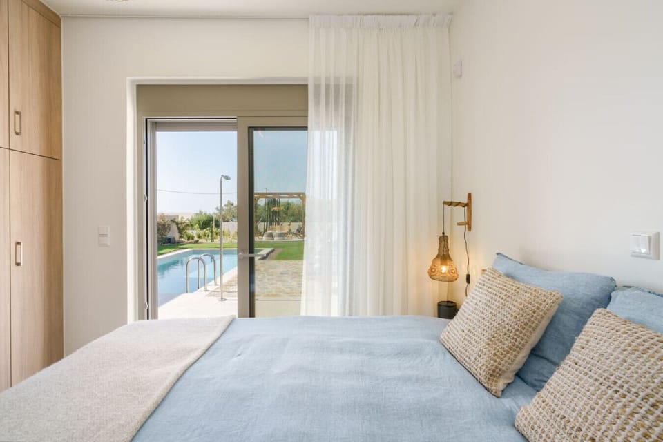 King size bedroom with private pool access and cozy décor.