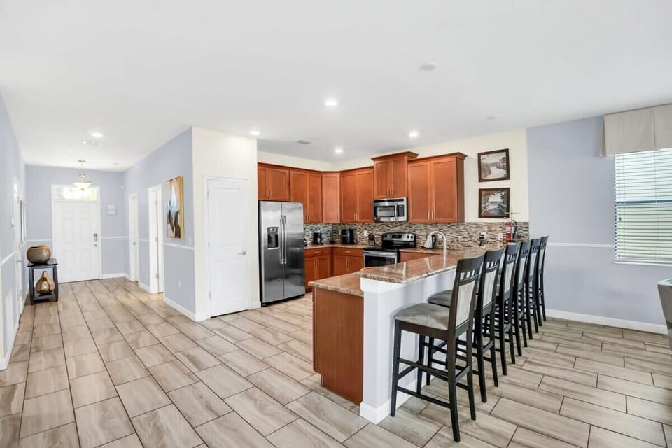 Elevate vacation dining in this fully furnished chef's kitchen, featuring stainless steel appliances, generous counter space, and everything needed to prepare anything from a quick breakfast to a memorable family dinner.
