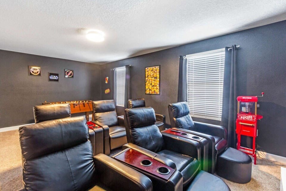 Gather everyone for movie night in the private theater featuring plush seating and a foosball table for added family fun and entertainment.