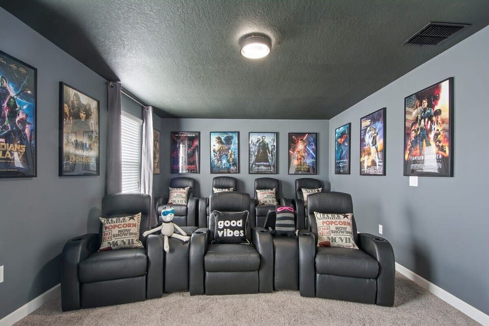 Bring the big-screen experience home in this immersive themed theater room, featuring comfortable stadium seating and the perfect atmosphere for family movie nights.