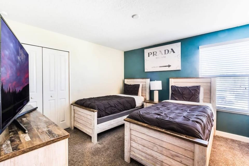 Comfortable bedroom featuring two twin beds, a flat-screen TV, high-speed Wi-Fi, and a welcoming space for kids, teens, or additional guests.