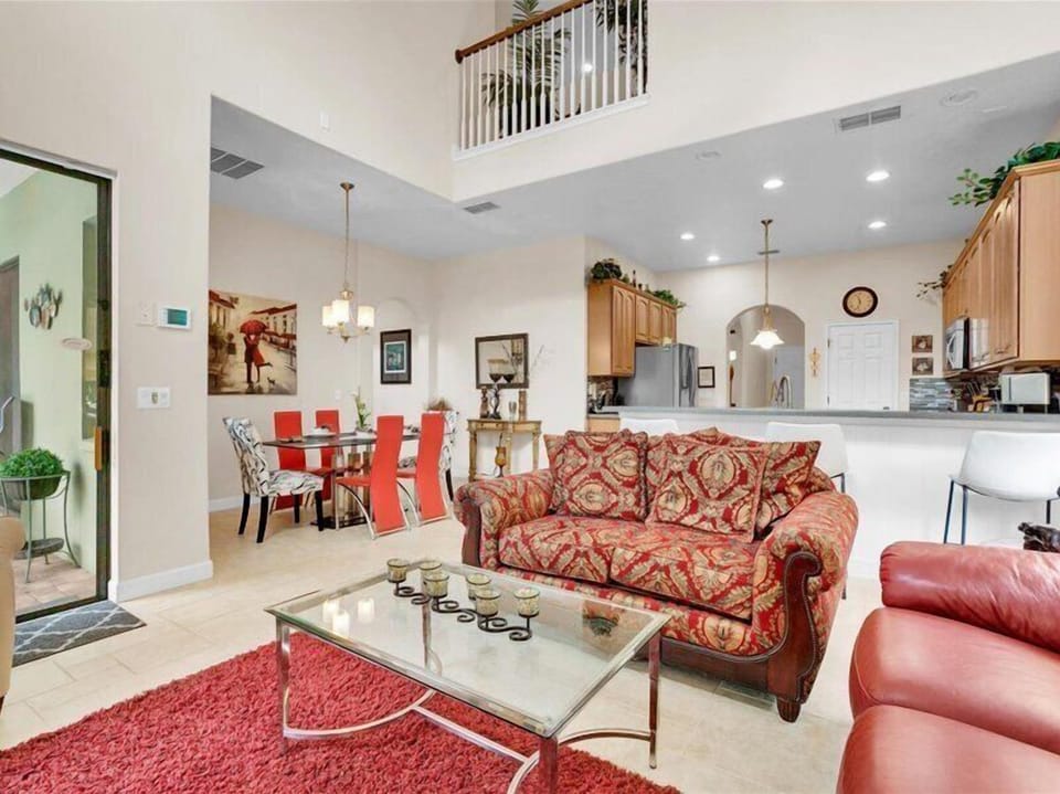 Spacious open-concept living area with luxurious furnishings and high ceilings.
